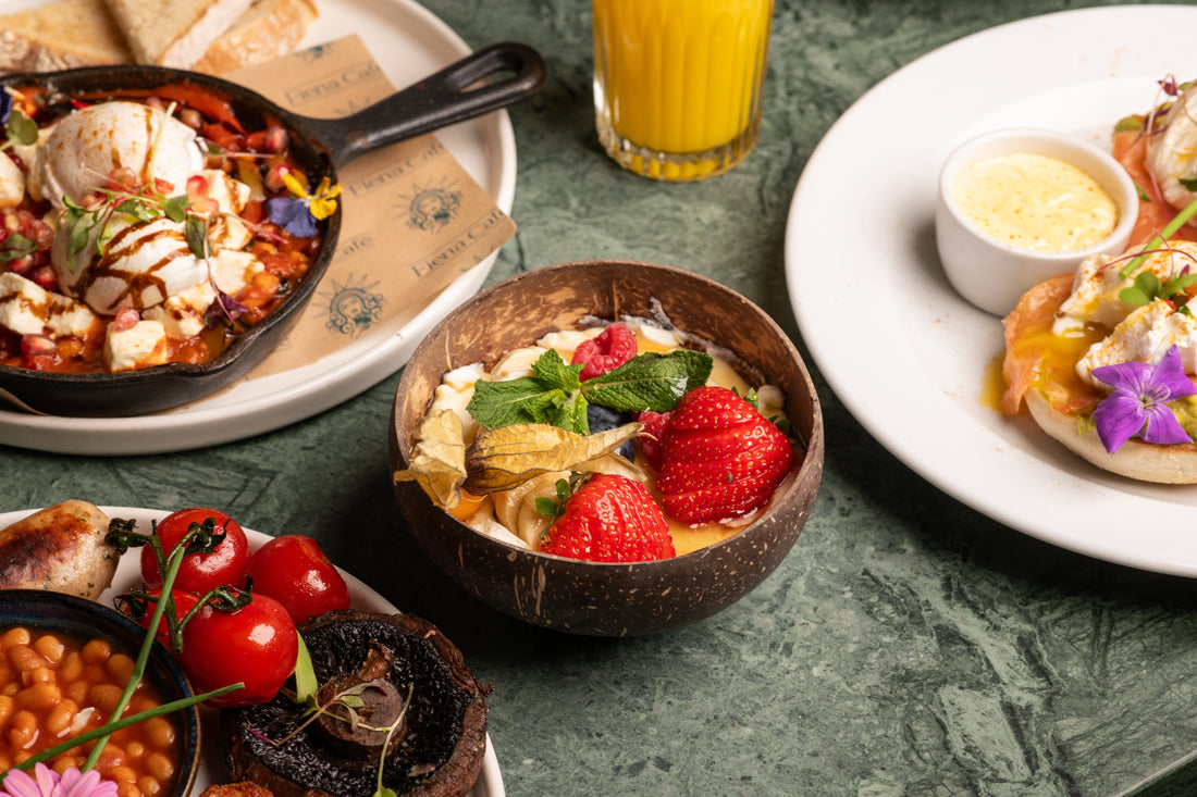 Fiena breakfast spread in King's Cross: shakshuka skillet, smoothie bowl and eggs royale on a green marble table