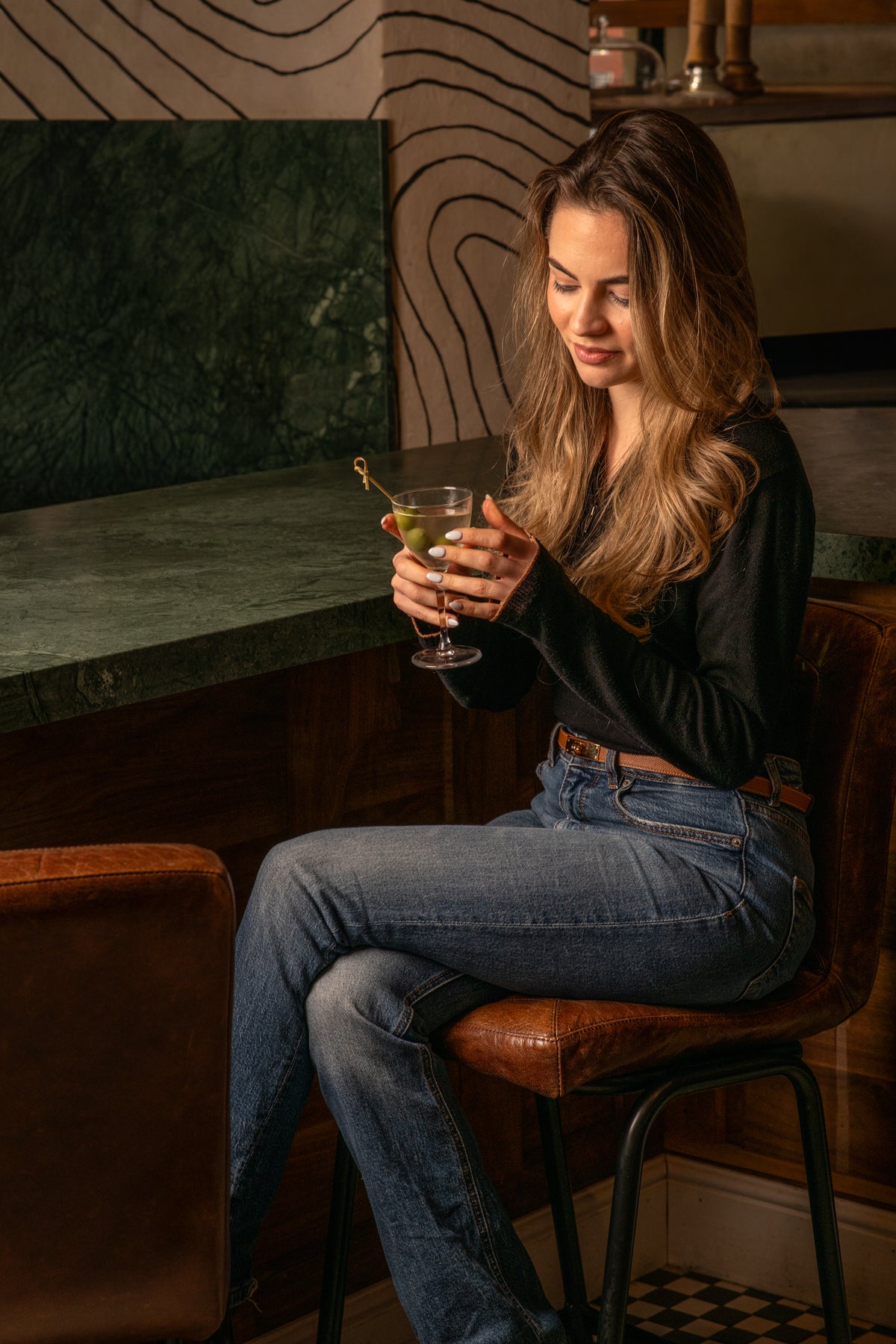 Enjoying a cocktail at the bar inside Fiena, King's Cross